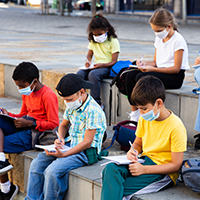 elementary students outside studying